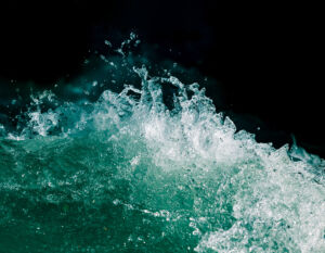 Splash of stormy water in the ocean on a black background