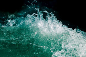Splash of stormy water in the ocean on a black background