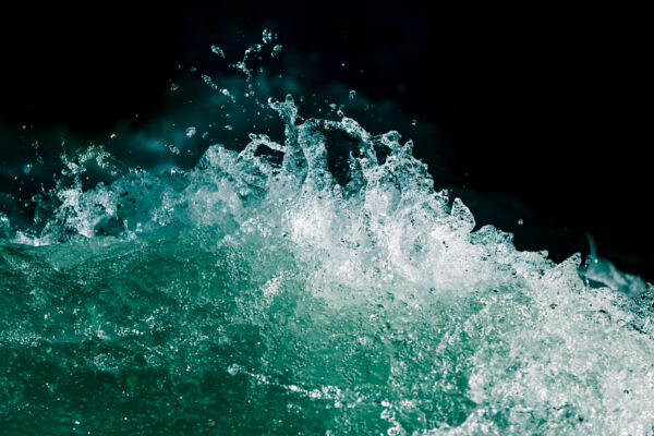 Splash of stormy water in the ocean on a black background