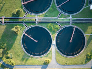 Aerial view of wastewater treatment plant with settling tanks.