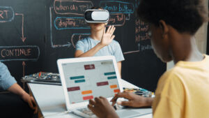 African boy programing system while caucasian girl enter metaverse while sitting at blackboard with engineering code written.Highschool girl wearing VR or headset in STEM technology. Edification.